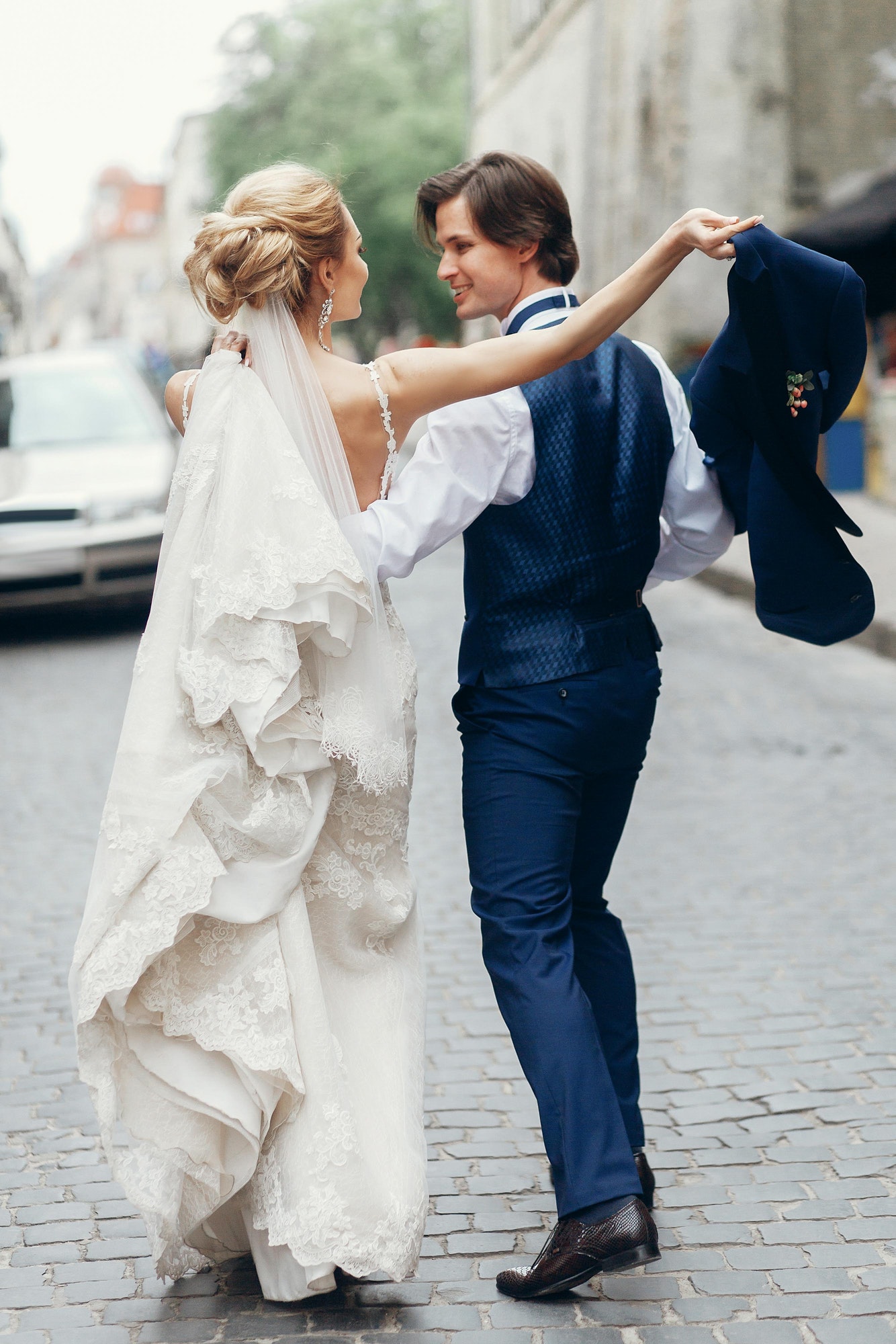 bride-and-groom-dancing-and-having-fun-in-city-street-.jpg
